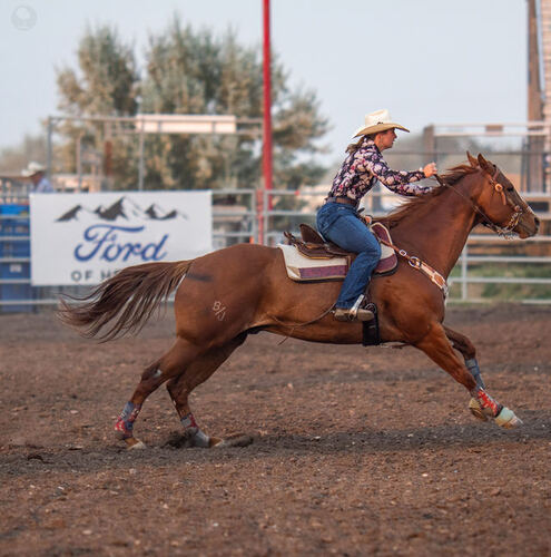 Barrel racer rounding a turn at full speed